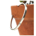 sterling-silver-lined-cuff-bracelet-hanging-on-side-of-clay-pot