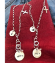 two-Sterling-silver-chain-mom-charm-necklaces-on-red-leather-and-denim-background