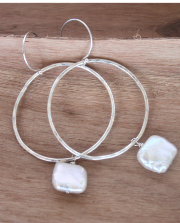 sterling hoop pearl earrings on wood