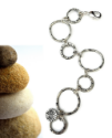 chunky silver circles bracelet next to rocks