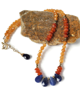 orange  & blue gemstone collar necklace on rock