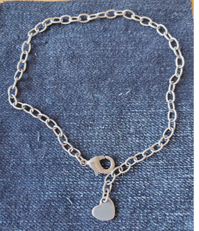 silver heart anklet on denim
