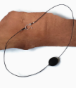 Simple black linen cord with black crystal necklace on wood