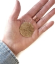 big brass disc earrings in open hand