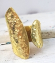 Wide hammered brass wrap ring on white distressed wood