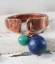 Antimicrobial copper cuff ring with blue gemstone on white distressed background