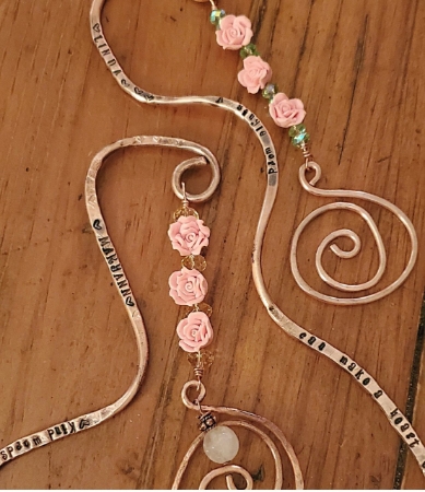 Copper crystal spiral bookmarks on wood
