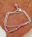 pink gemstone silver rolo chain bracelet on wood