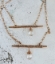 wired wrapped bronze bar crystal chain necklaces on white distressed wood