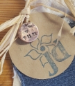 round copper charm stamped with new baby birthdate