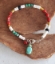multi color gemstone silver clasp bracelet  on wood