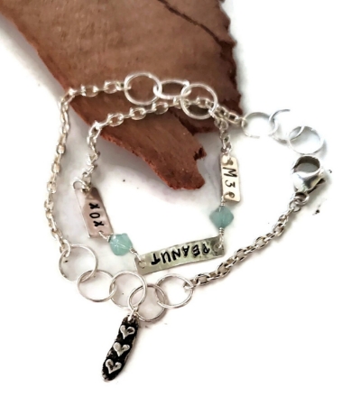 Silver double wrap birthstone charm bracelet on white with wood