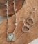 abstract silver earrings & eclectic heart necklace on wood