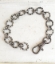 silver textured link bracelet with extra big clasp on white trunk
