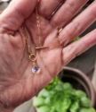 rainbow quartz gold chain toggle necklace held in hand for size reference