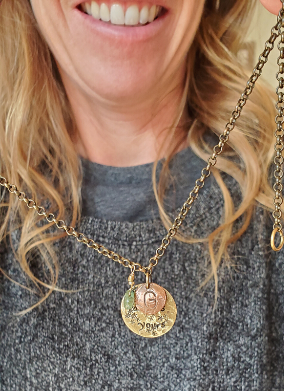 Coach is holding her custom necklace gift