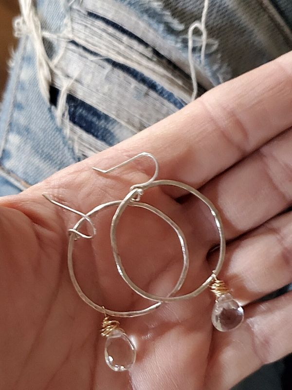 wearing blue jeans with upscale hoop earrings