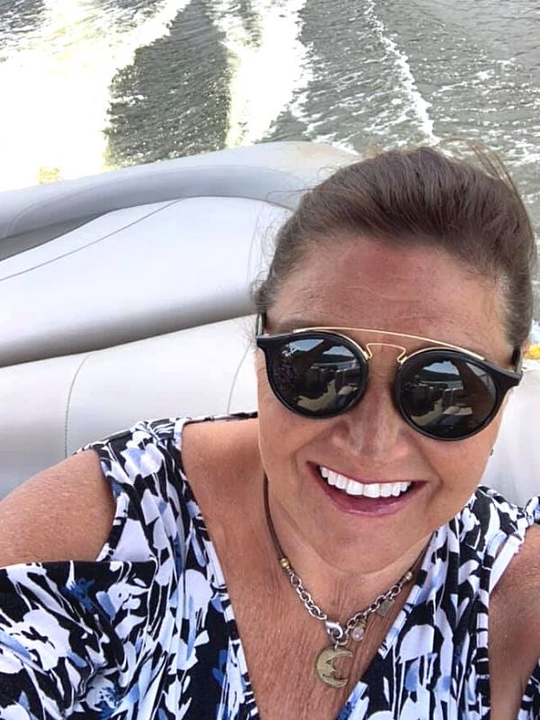 in a boat with a brass moon necklace