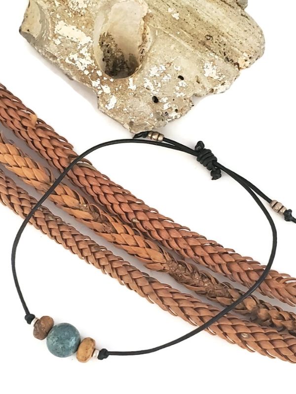 black leather beaded bracelet on rock