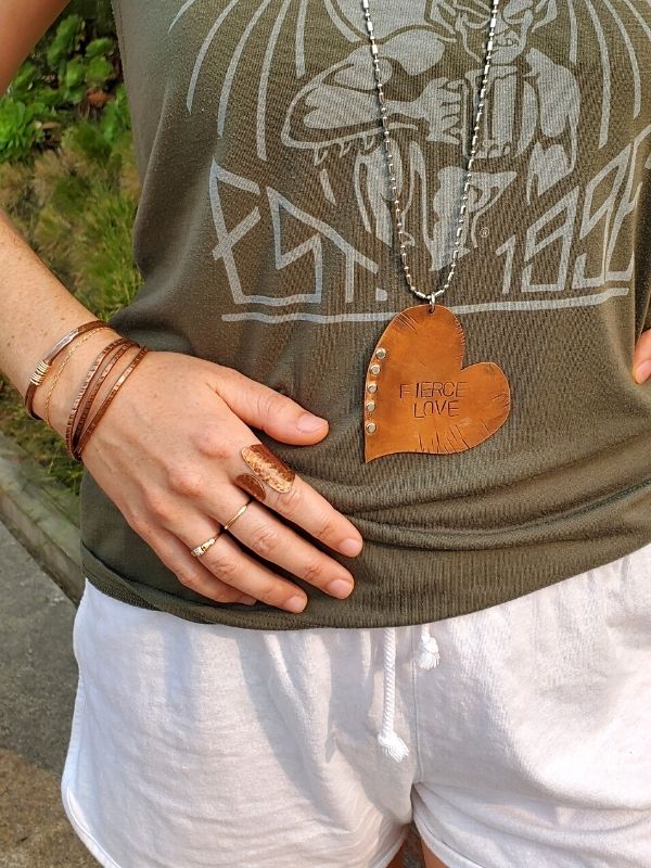 wearing army green outfit and copper jewerly