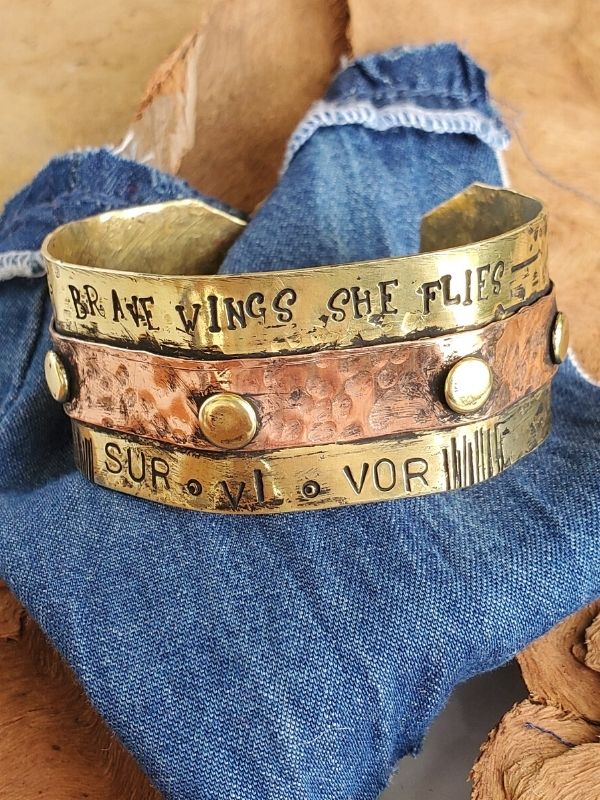 riveted metal survivor cuff on stones