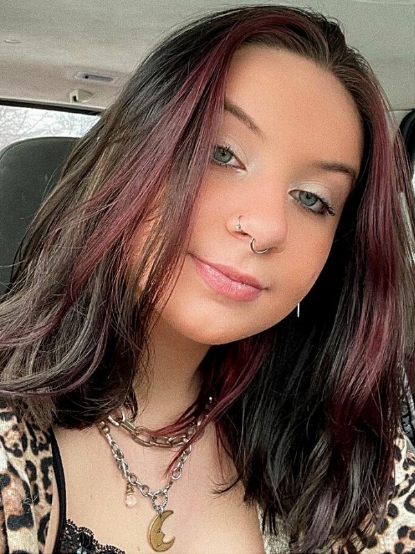 in car wearing moon necklace