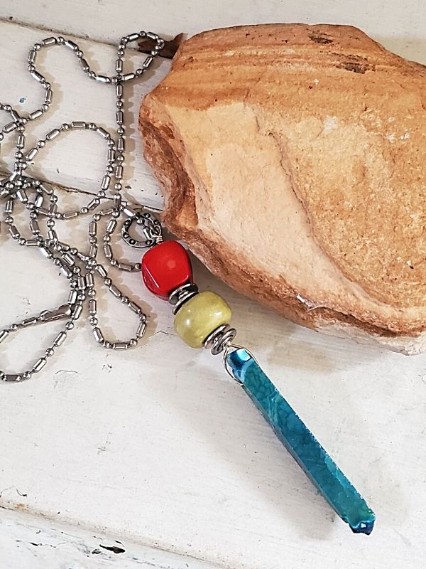 Colorful gemstone stick necklace on rock