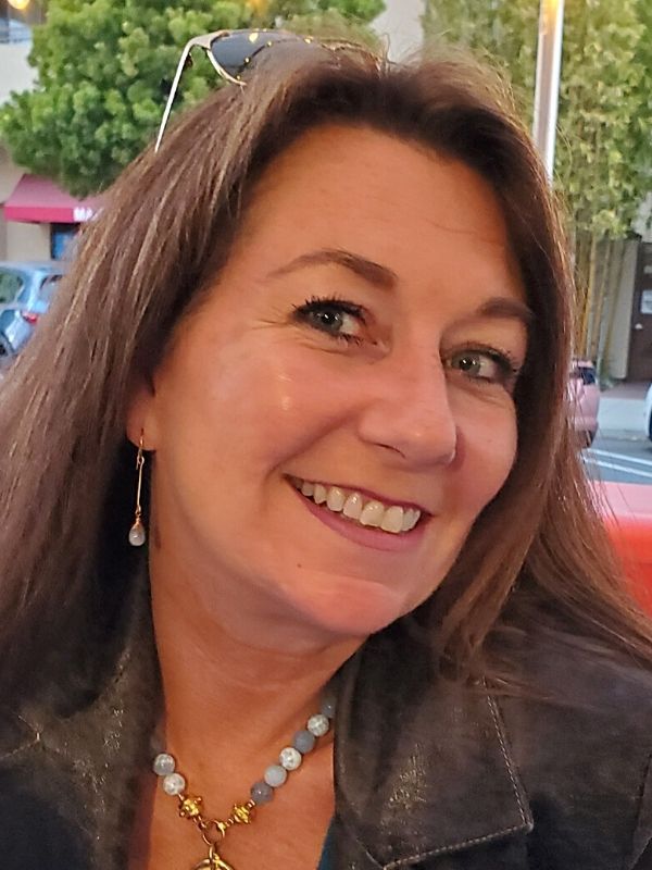 female wearing blue gemstone stick earrings