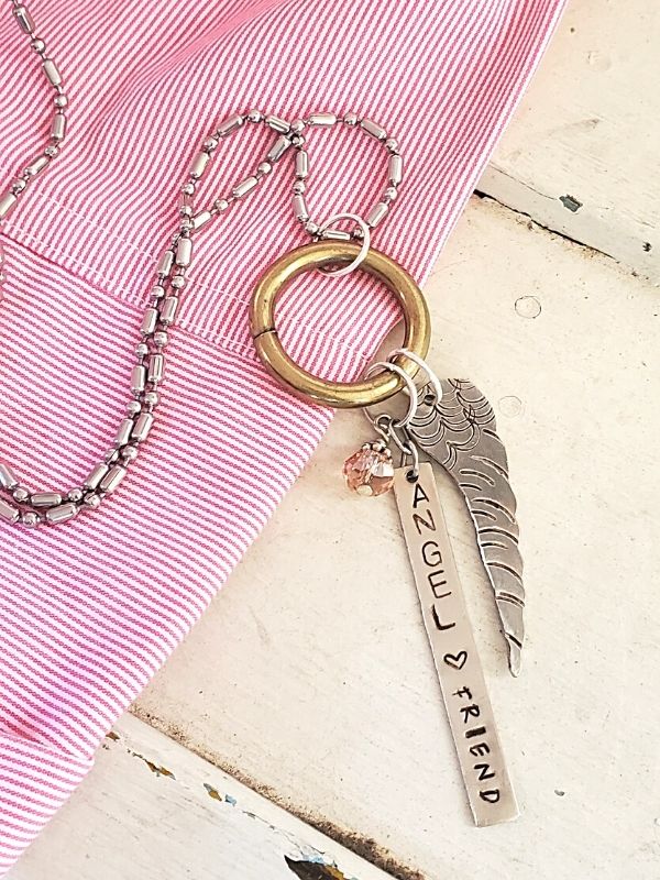 angel wing necklace with pink striped blouse