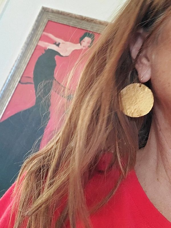 wearing big round hammered gold disc earrings