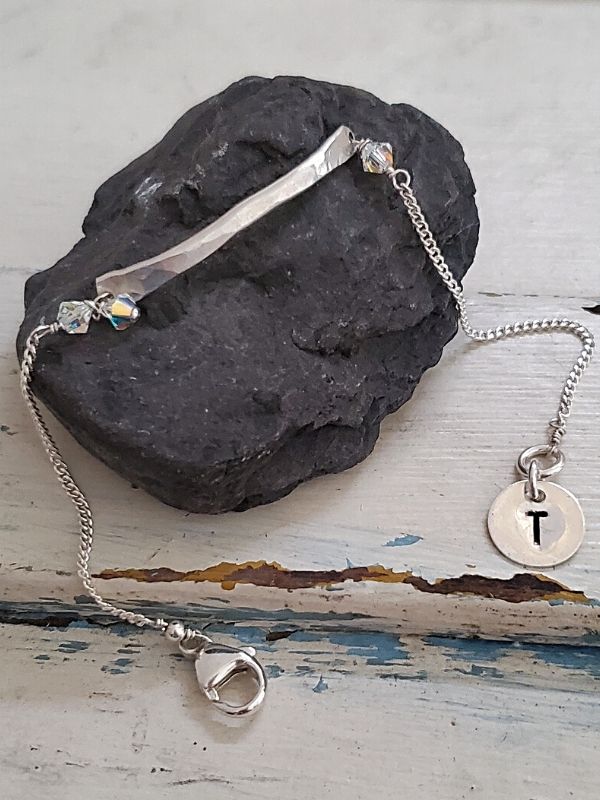silver bar chain initial bracelet on dark rock