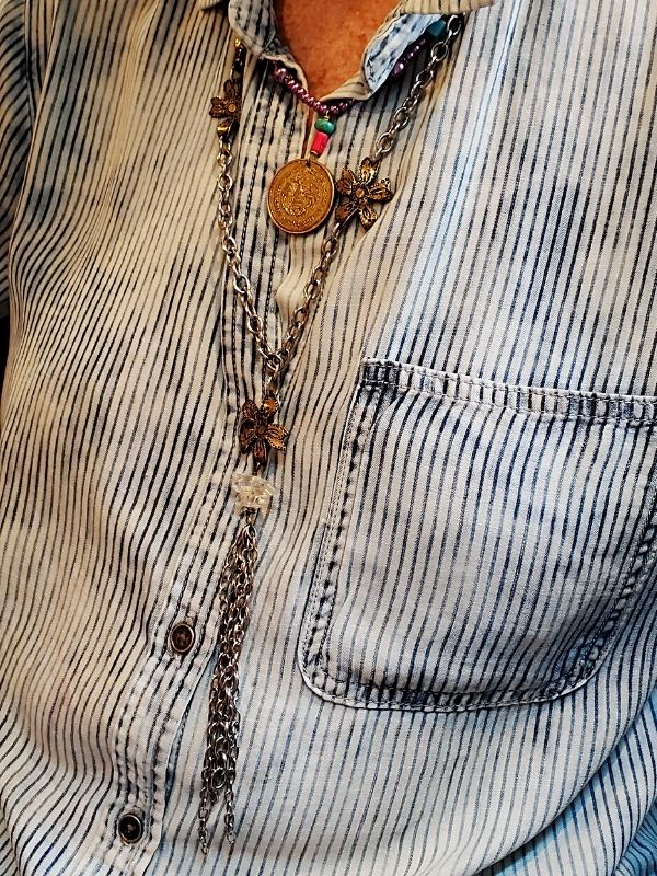 wearing striped shirt and flower necklace