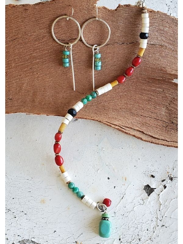 multi color gemstone earrings bracelet on table