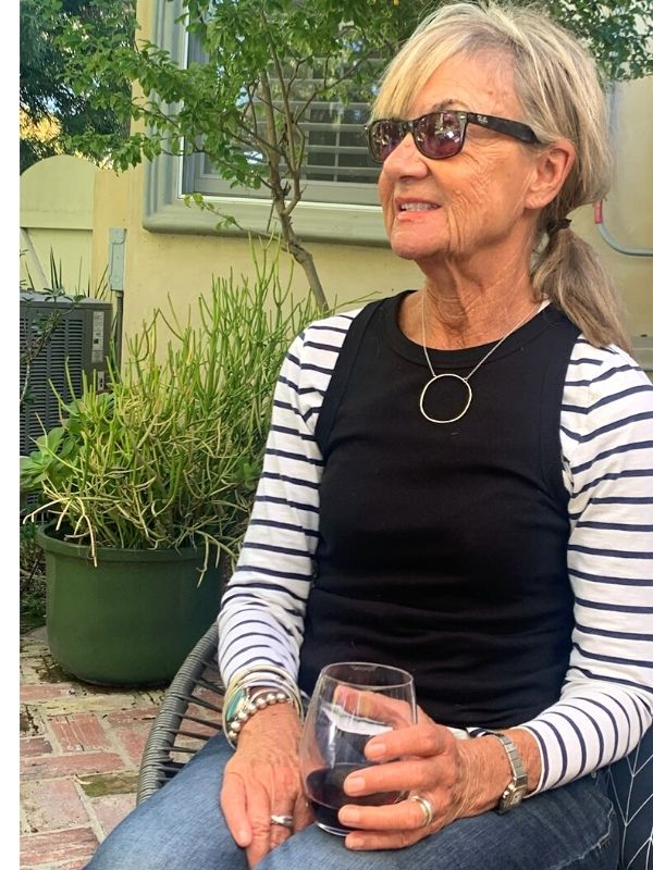 wearing a big silver circle necklace