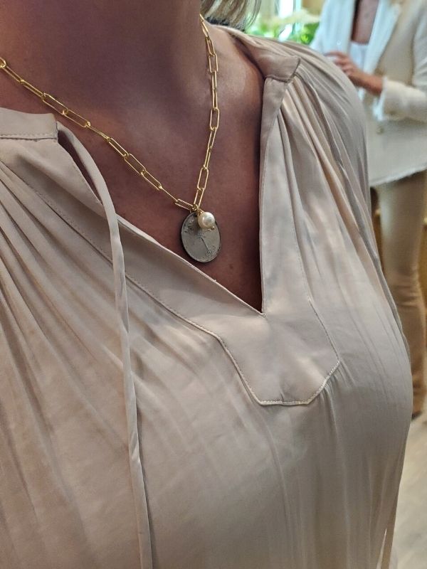 Isreal coin necklace being worn