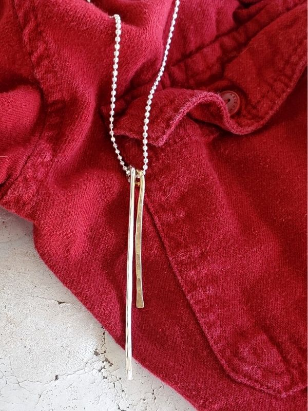 silver gold necklace red flannel shirt