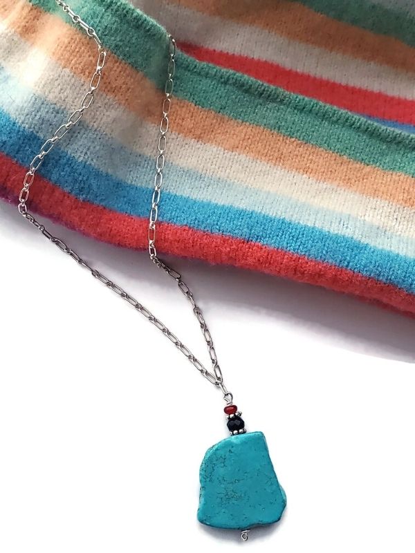 striped hat with turquoise necklace