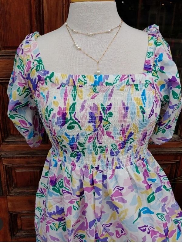 pearl necklaces on mannequin w/floral dress