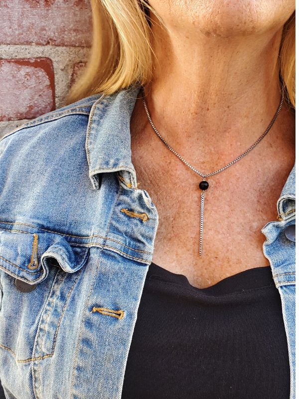 model wearing black gemstone silver chain Y necklace