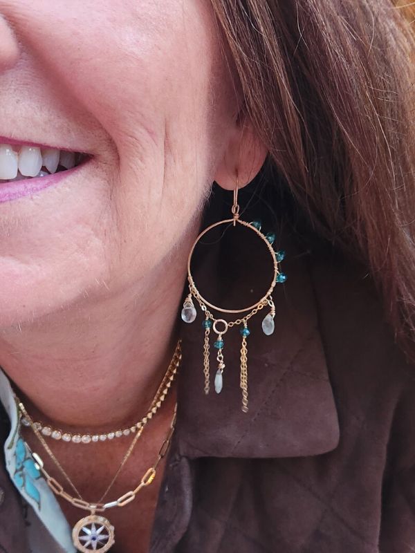 female wear gemstone gold chandelier earrings and layered necklaces