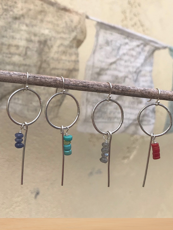 prayer flags and a row of gemstone hoop earrings