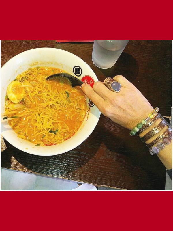 ramen soup and a bracelet stack on arm
