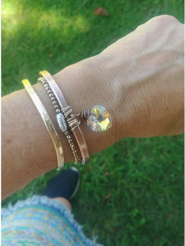 Crystal heart bracelet on arm in bracelet stack